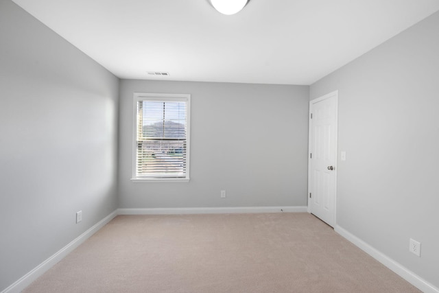 empty room featuring light carpet