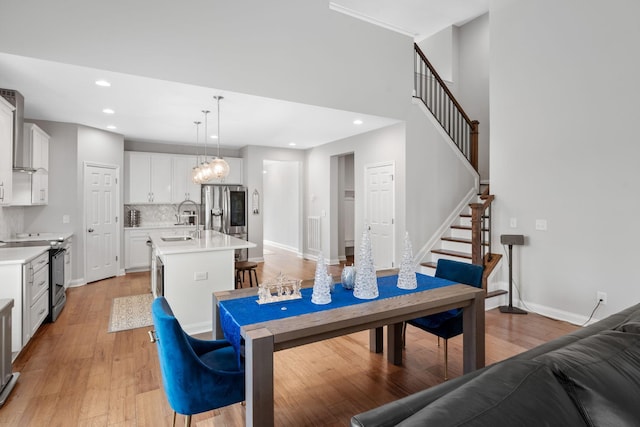 dining room featuring light wood-type flooring and sink