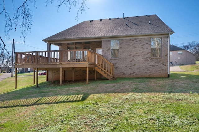 rear view of house featuring a yard and a deck