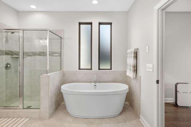 bathroom featuring tile patterned flooring and independent shower and bath