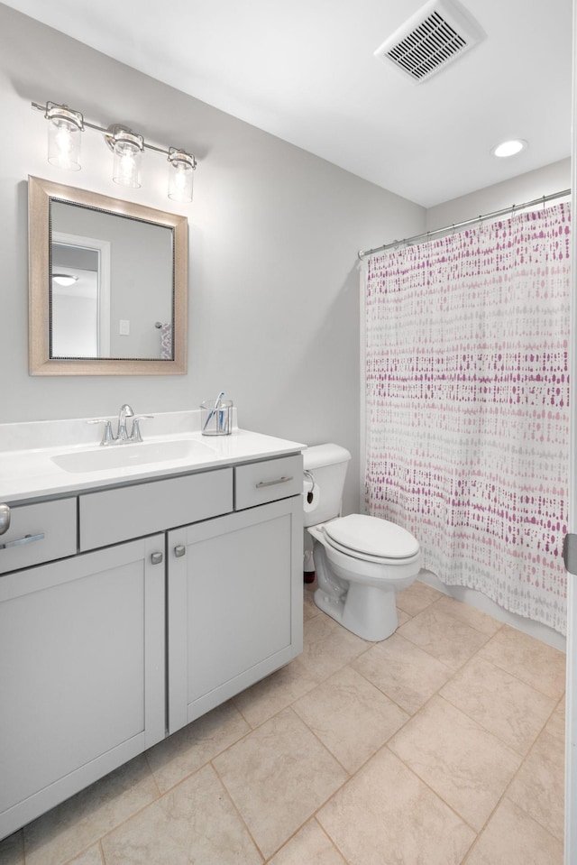 bathroom featuring tile patterned flooring, vanity, and toilet