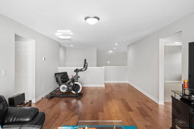 workout area with hardwood / wood-style floors