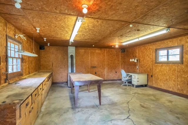 basement featuring wooden walls