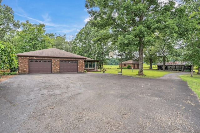 exterior space featuring a gazebo, a front yard, and a garage