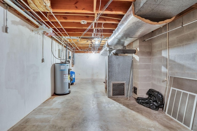 basement featuring electric water heater and heating unit