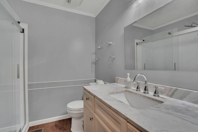 bathroom with toilet, vanity, ornamental molding, and hardwood / wood-style flooring