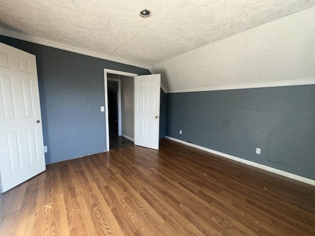 bonus room with hardwood / wood-style floors, a textured ceiling, and vaulted ceiling