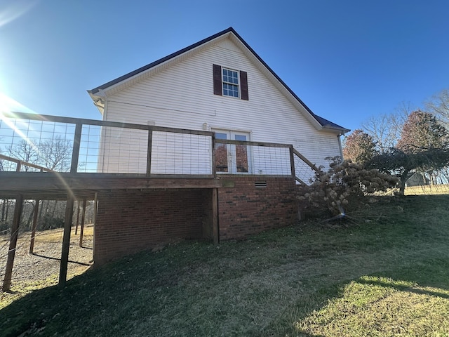 back of property with a lawn and a deck