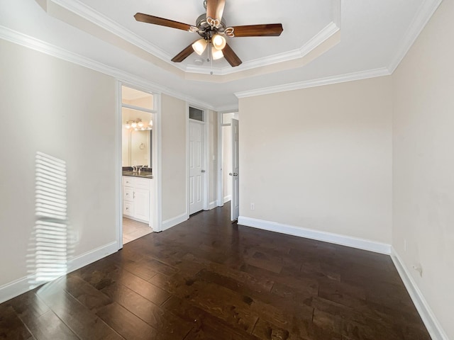 unfurnished room with dark hardwood / wood-style flooring, ceiling fan, a raised ceiling, and crown molding