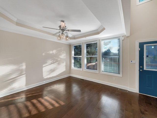 entryway featuring dark hardwood / wood-style floors, a raised ceiling, ceiling fan, and ornamental molding