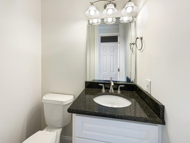 bathroom featuring toilet and vanity