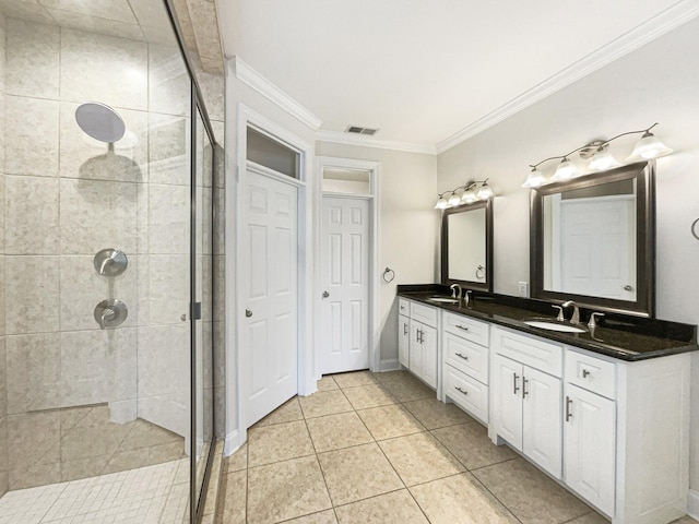 full bathroom featuring a sink, crown molding, a stall shower, and visible vents