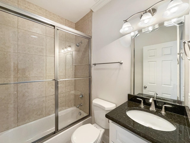 bathroom with toilet, vanity, and enclosed tub / shower combo