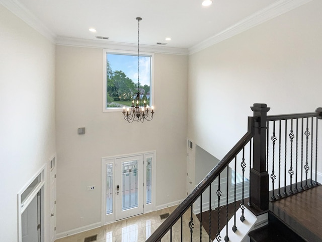 staircase with a notable chandelier, visible vents, baseboards, ornamental molding, and recessed lighting