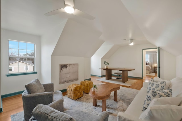 living room with ceiling fan, light hardwood / wood-style floors, and lofted ceiling