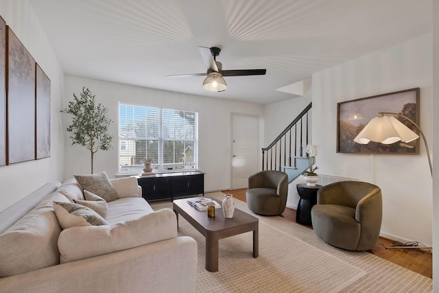 living room featuring ceiling fan and light hardwood / wood-style floors