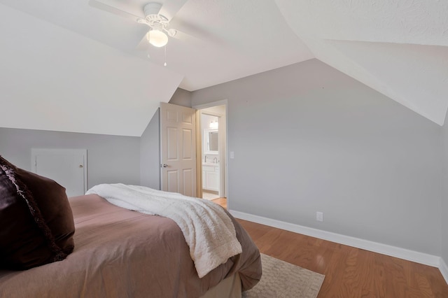 bedroom with ceiling fan, lofted ceiling, and hardwood / wood-style flooring