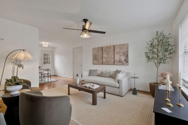 living room featuring ceiling fan and light hardwood / wood-style flooring