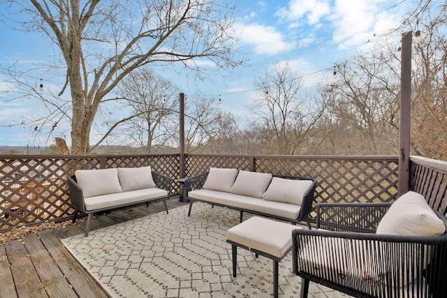 wooden deck with an outdoor living space