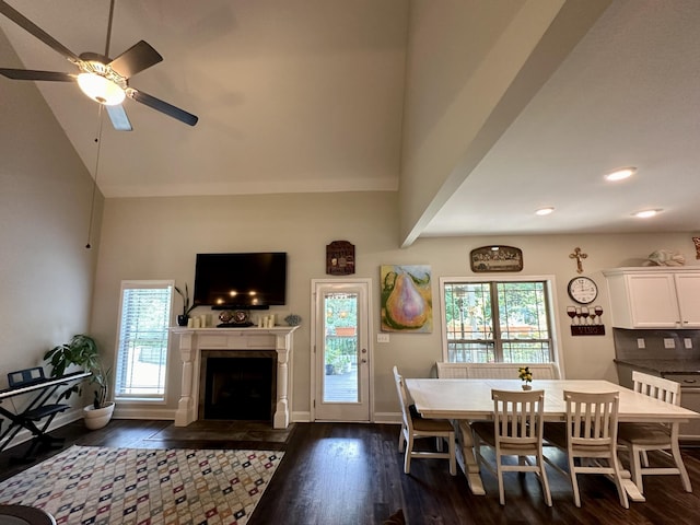 dining room with ceiling fan, high vaulted ceiling, and dark hardwood / wood-style floors