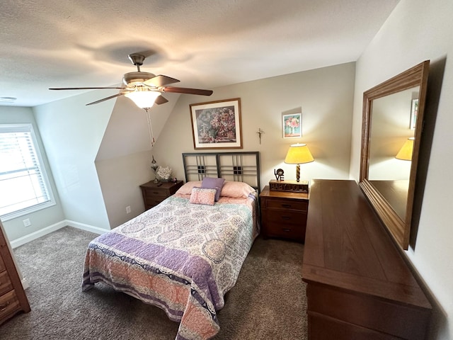 bedroom featuring a textured ceiling, ceiling fan, dark carpet, and lofted ceiling