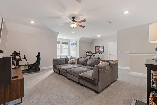 carpeted living room with ceiling fan