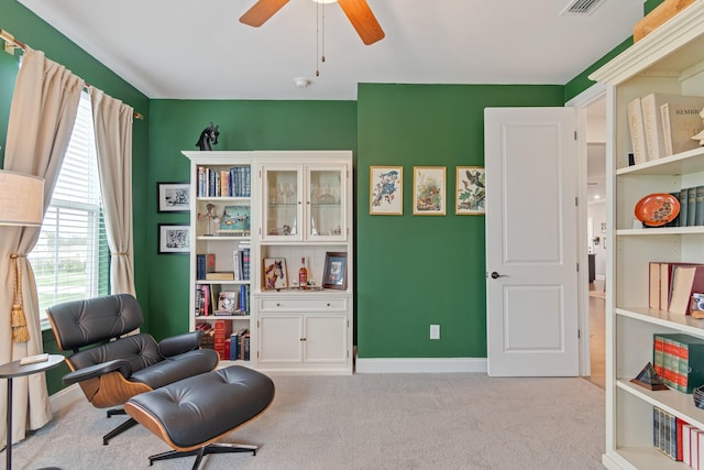 sitting room featuring ceiling fan and light carpet