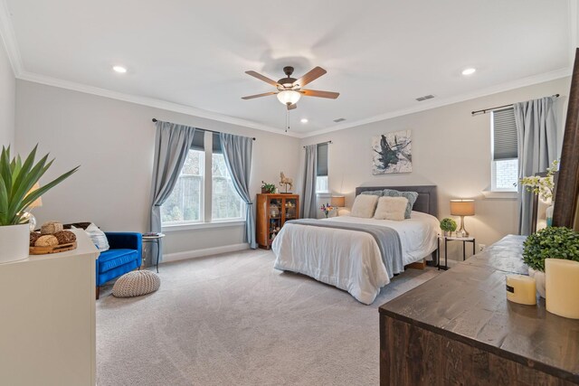 bedroom with ceiling fan, ornamental molding, light colored carpet, and multiple windows