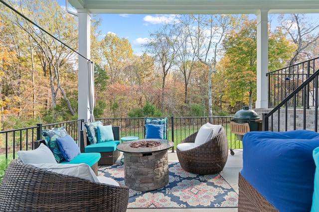 wooden deck with an outdoor living space with a fire pit