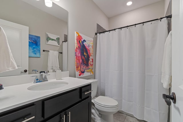 bathroom featuring tile patterned flooring, vanity, and toilet