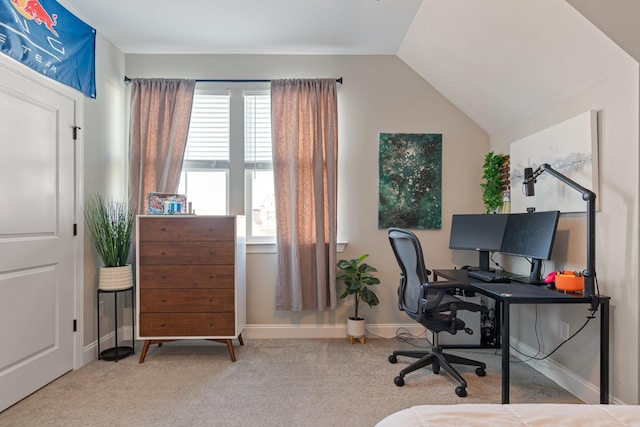 carpeted home office featuring lofted ceiling