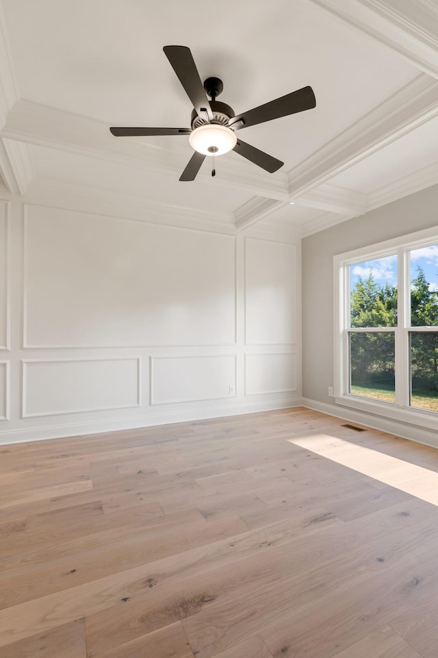 empty room with beam ceiling, ceiling fan, coffered ceiling, light wood-type flooring, and ornamental molding