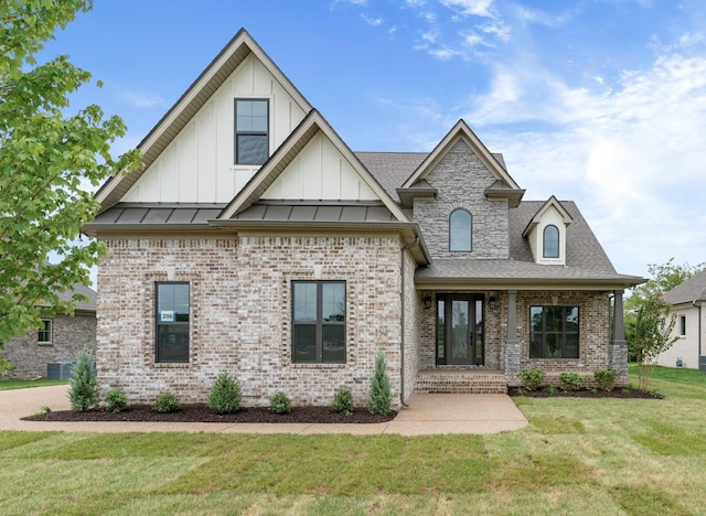 view of front of home with cooling unit and a front lawn