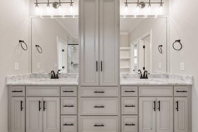 bathroom with vanity, crown molding, and walk in shower