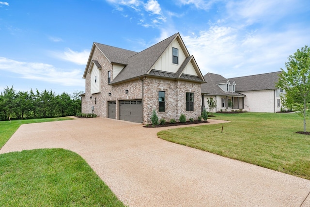 view of front of home with a front yard and a garage