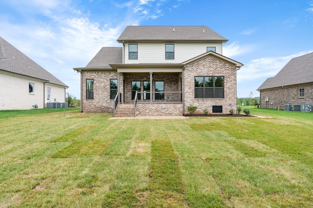 rear view of house featuring a lawn