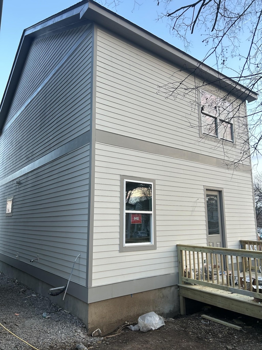 view of side of property with a wooden deck