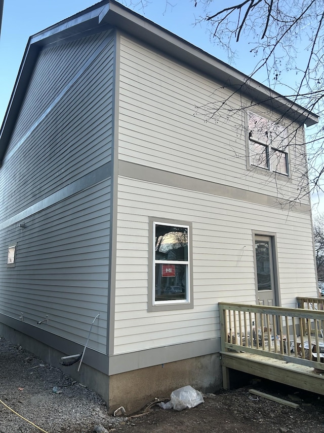 view of side of property with a wooden deck