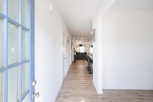 hallway with light hardwood / wood-style floors