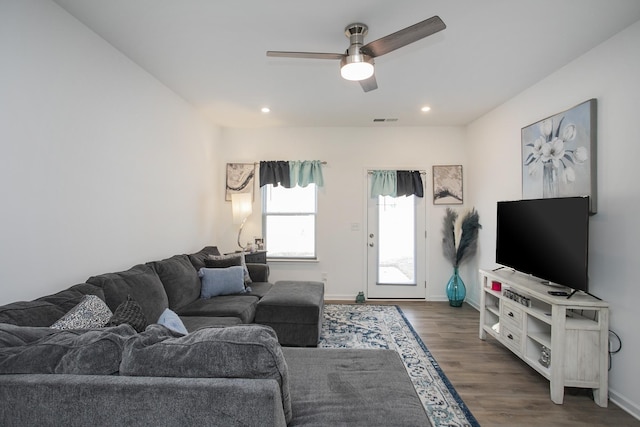 living room with dark hardwood / wood-style floors and ceiling fan