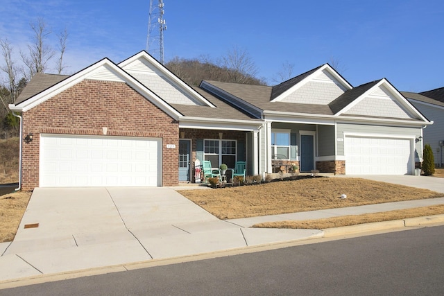 craftsman house featuring covered porch and a garage