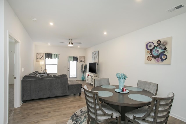 dining room featuring wood-type flooring and ceiling fan