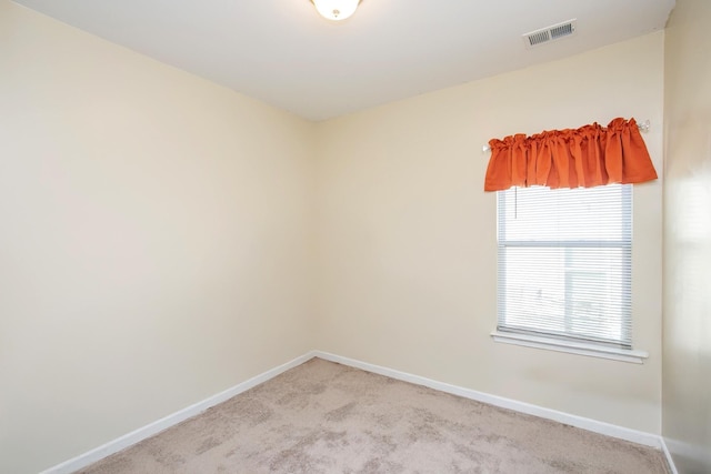 spare room with light colored carpet