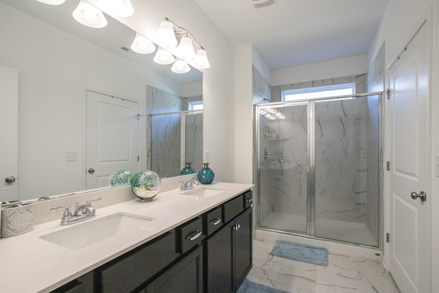 bathroom with vanity and a shower with door