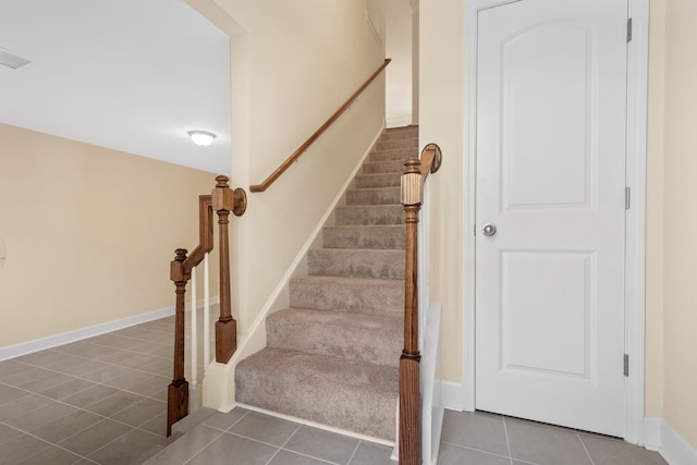 staircase featuring tile patterned flooring