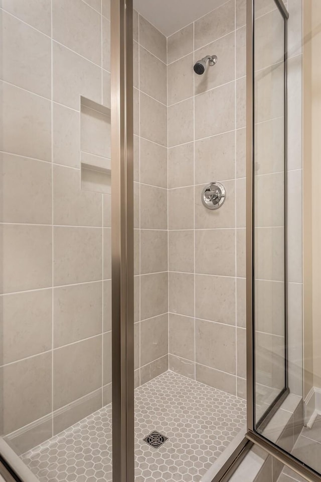 bathroom with a shower with shower door