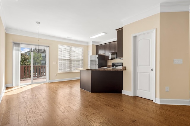 kitchen with black stove, a notable chandelier, stainless steel fridge, decorative light fixtures, and dark brown cabinets