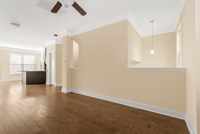 unfurnished living room featuring ceiling fan, dark hardwood / wood-style flooring, and ornamental molding