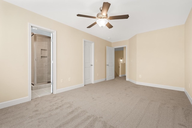 unfurnished bedroom with light colored carpet, ensuite bath, and ceiling fan