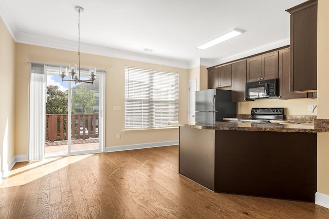 kitchen with black appliances, dark brown cabinets, pendant lighting, and crown molding